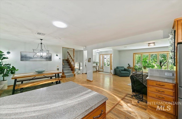 14 Cougar Ln, Boise, ID 83716 - bedroom with light wood finished floors and a chandelier