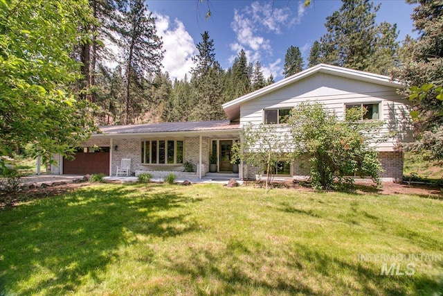 14 Cougar Ln, Boise, ID 83716 - tri-level home with an attached garage, brick siding, and a front lawn