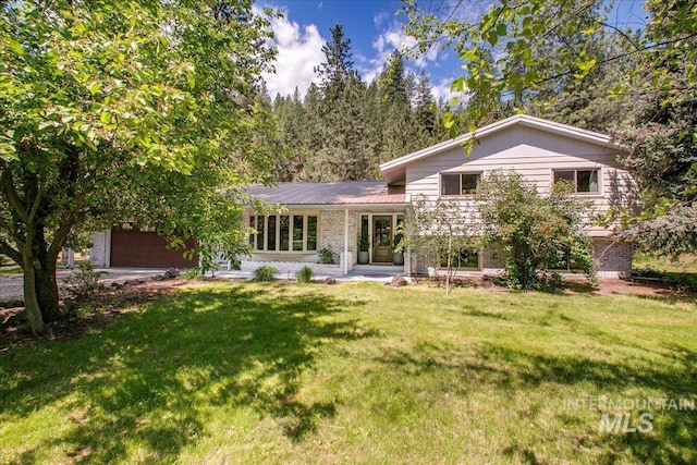 14 Cougar Ln, Boise, ID 83716 - tri-level home with brick siding, a front lawn, and metal roof