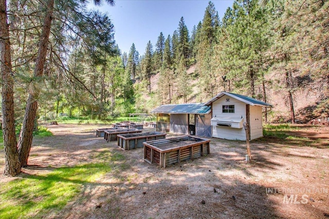 14 Cougar Ln, Boise, ID 83716 - exterior space with an outbuilding, a wooded view, and exterior structure