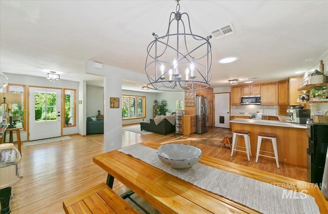 14 Cougar Ln, Boise, ID 83716 - dining room with a chandelier and light wood-type flooring