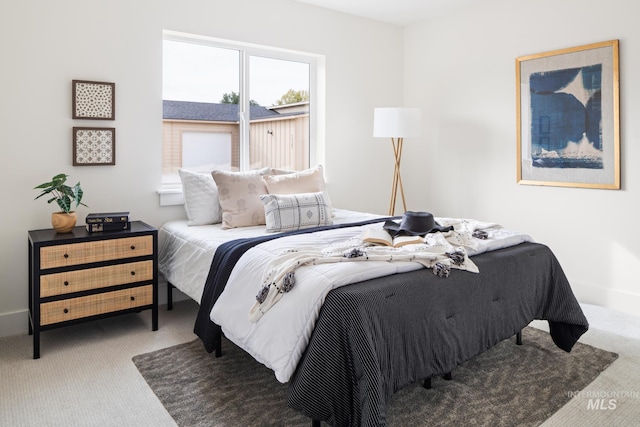 bedroom with carpet flooring and baseboards