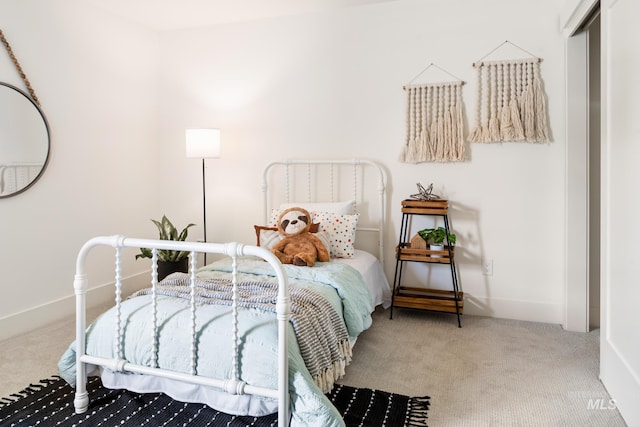 bedroom featuring carpet and baseboards