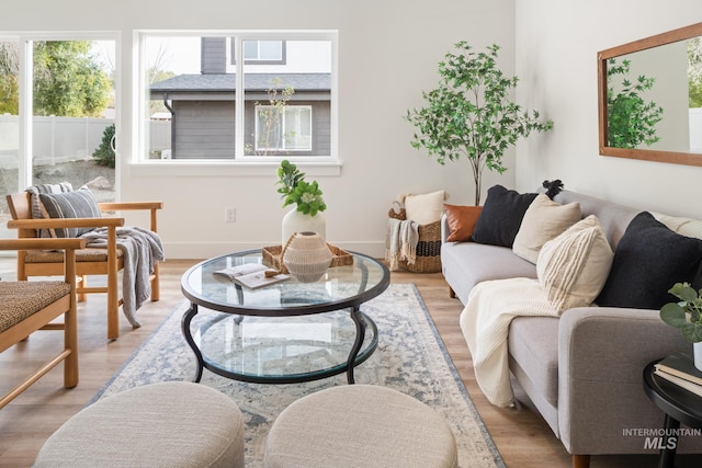 living room featuring light wood-type flooring and baseboards