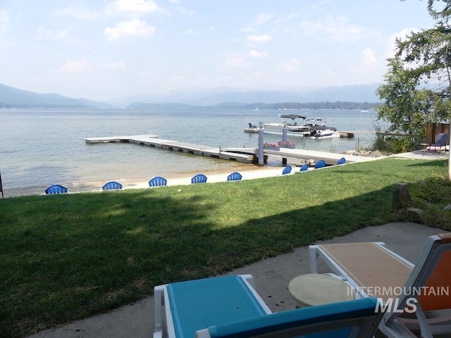 view of water feature with a dock and a mountain view