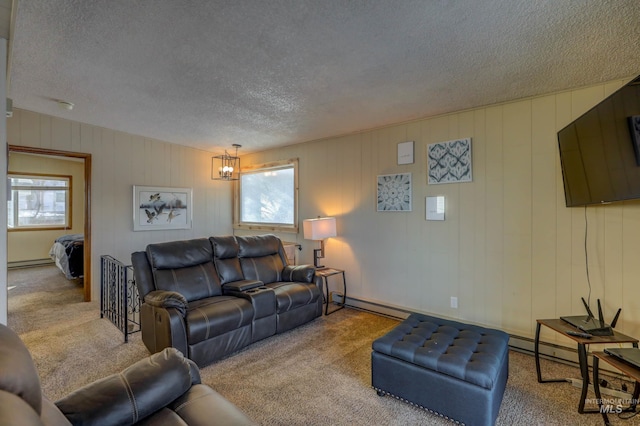 living room with a textured ceiling, light colored carpet, a chandelier, and a baseboard radiator