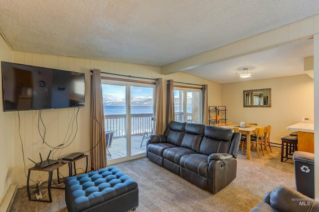 living room featuring baseboard heating, a textured ceiling, beamed ceiling, and carpet