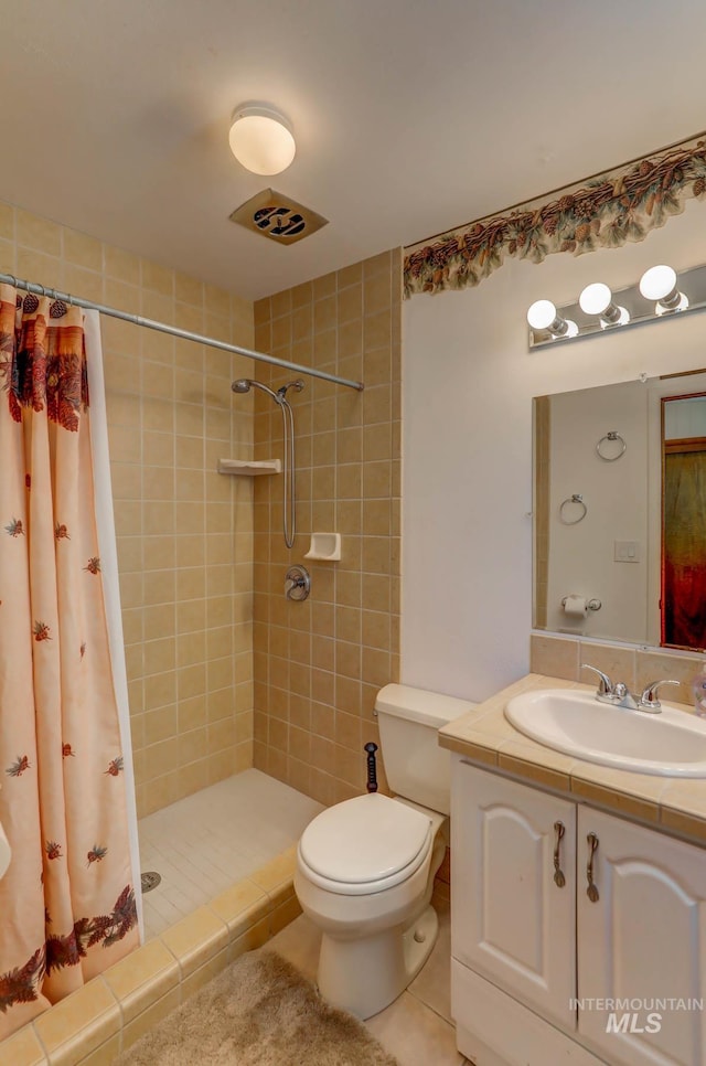 bathroom with vanity, toilet, tile patterned flooring, and a shower with shower curtain