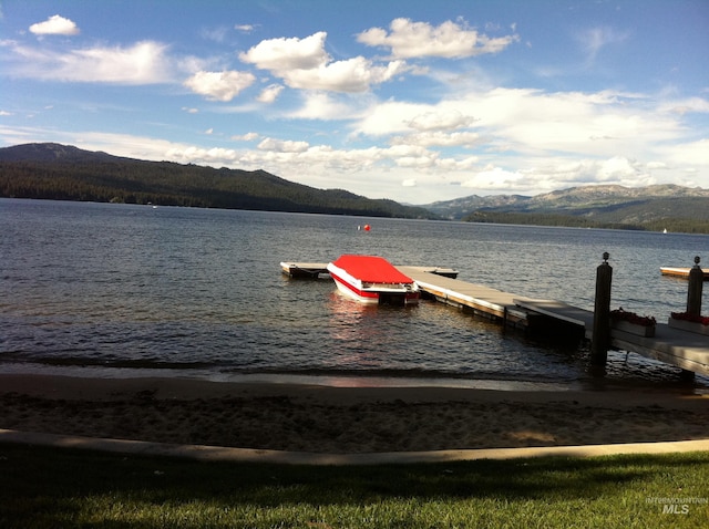 view of dock featuring a water and mountain view