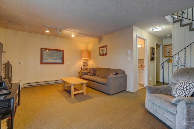 living room featuring baseboard heating, a textured ceiling, light carpet, and rail lighting