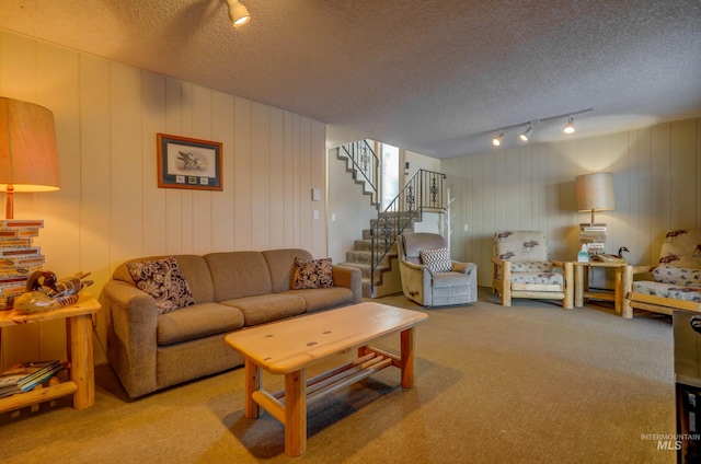 carpeted living room with a textured ceiling and rail lighting