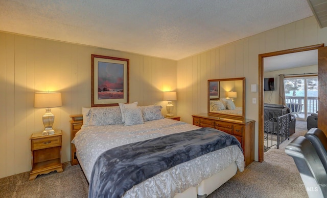 carpeted bedroom featuring access to outside and a textured ceiling