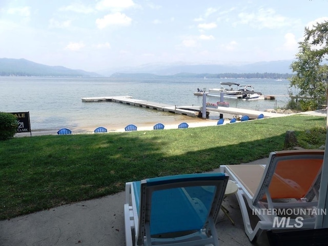 view of water feature with a dock and a mountain view