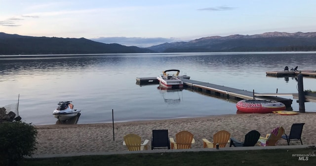 view of dock with a water and mountain view