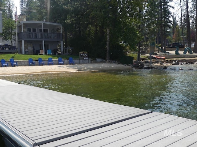 view of dock with a lawn