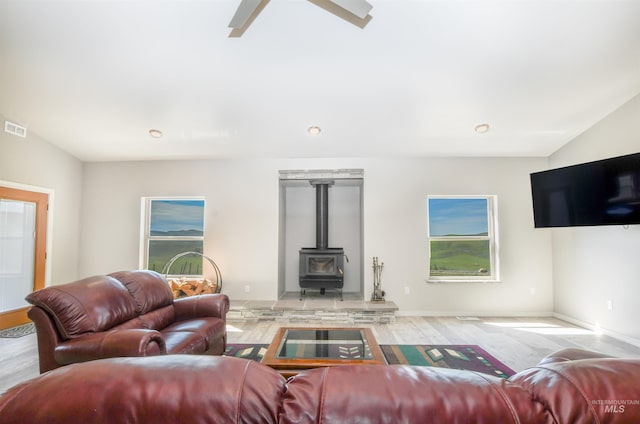 1190 Devils Elbow Rd, Weiser, ID 83672 - living area featuring a wood stove, wood finished floors, and baseboards