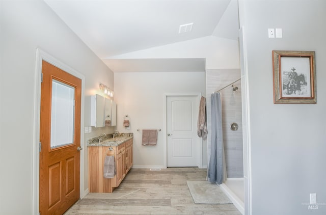 1190 Devils Elbow Rd, Weiser, ID 83672 - full bath featuring vanity, wood finished floors, lofted ceiling, and a tile shower