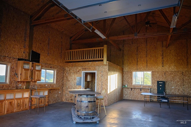 1190 Devils Elbow Rd, Weiser, ID 83672 - living area with finished concrete flooring, high vaulted ceiling, healthy amount of natural light, and a ceiling fan