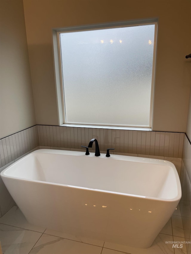 bathroom featuring a tub to relax in