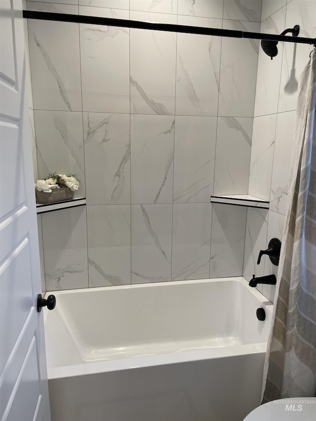 bathroom with shower / bathtub combination with curtain