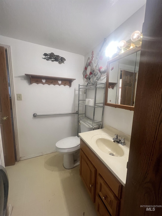 58438 Mansford Ave, Murphy Hot Springs, ID 83302 - bathroom featuring vanity, tile patterned floors, and toilet