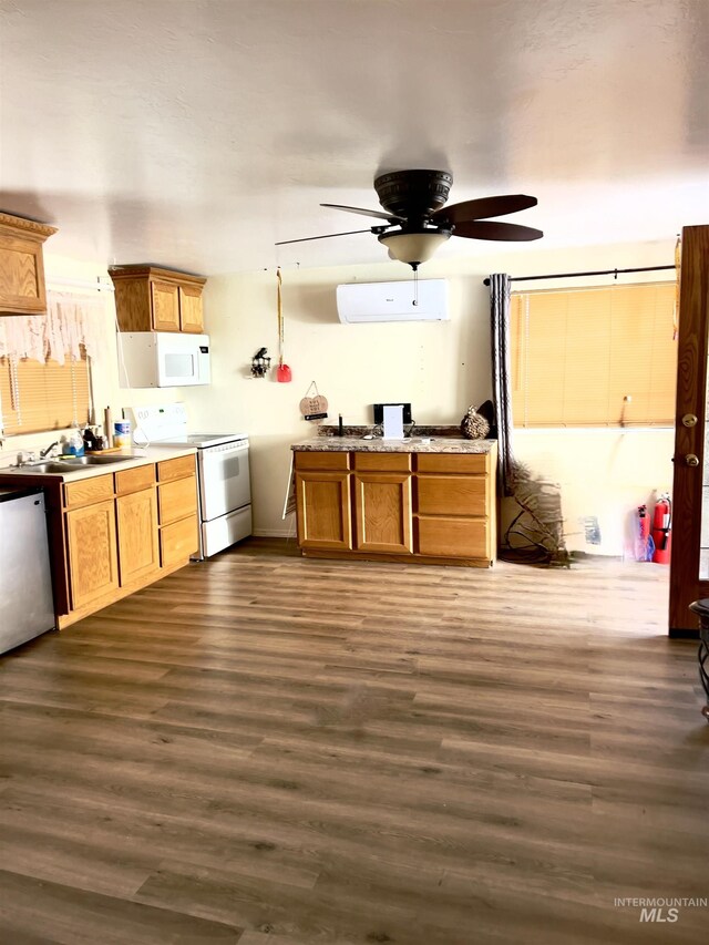58438 Mansford Ave, Murphy Hot Springs, ID 83302 - kitchen with a wall mounted air conditioner, white appliances, dark wood-type flooring, and brown cabinetry