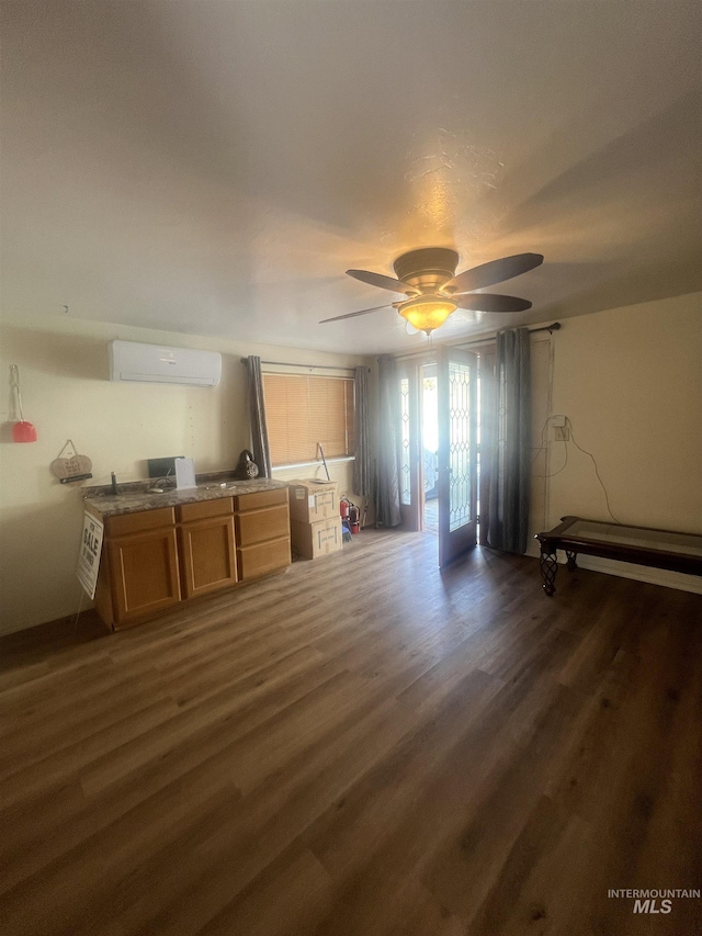 58438 Mansford Ave, Murphy Hot Springs, ID 83302 - unfurnished living room featuring dark wood finished floors, a wall mounted air conditioner, and ceiling fan