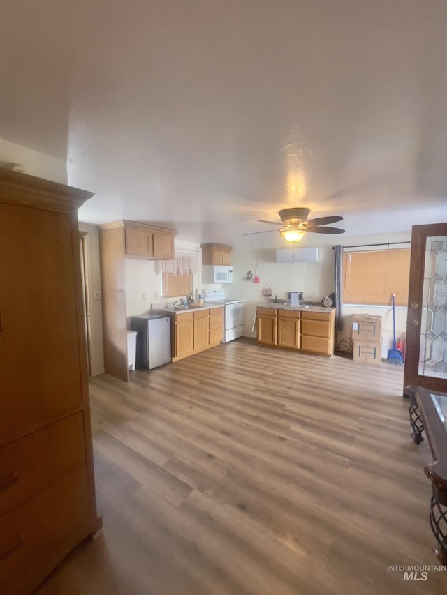 58438 Mansford Ave, Murphy Hot Springs, ID 83302 - kitchen featuring a ceiling fan, light brown cabinets, wood finished floors, white appliances, and light countertops