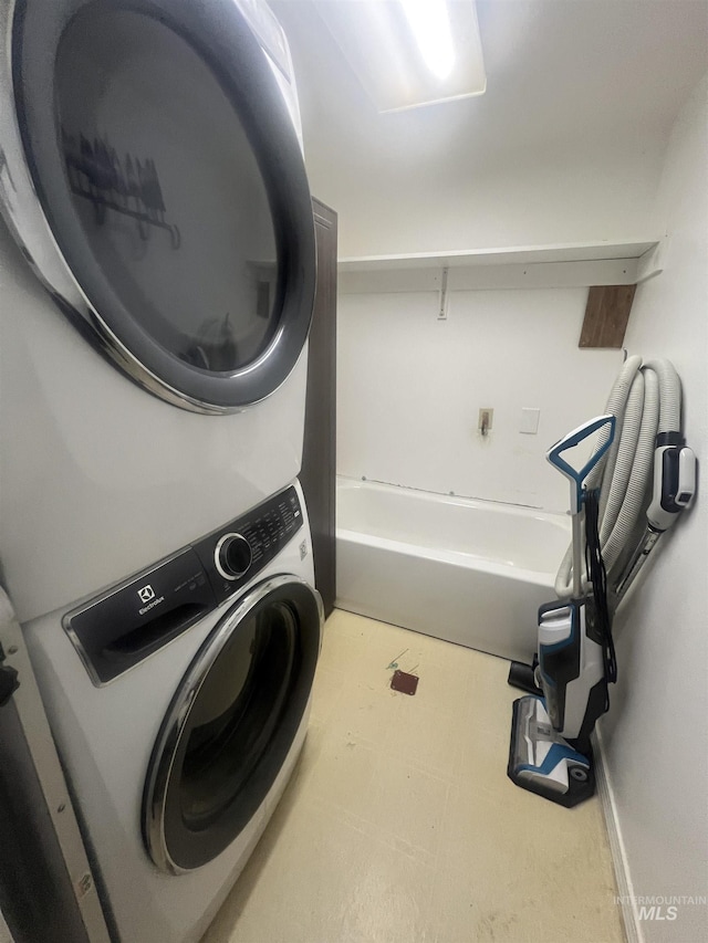 58438 Mansford Ave, Murphy Hot Springs, ID 83302 - washroom with tile patterned floors, laundry area, and stacked washer and dryer