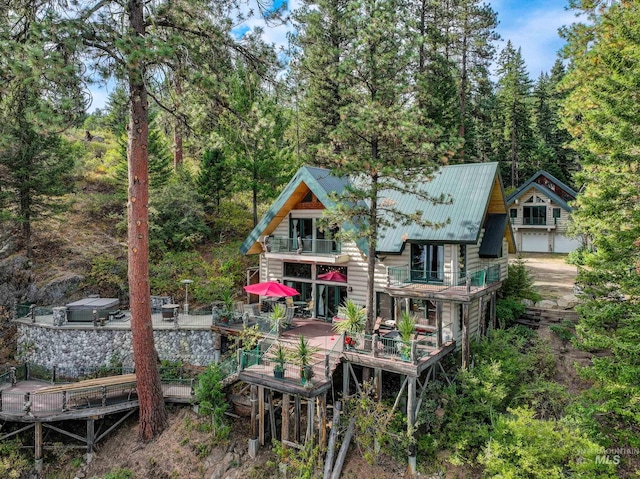 back of property with a balcony and a wooden deck