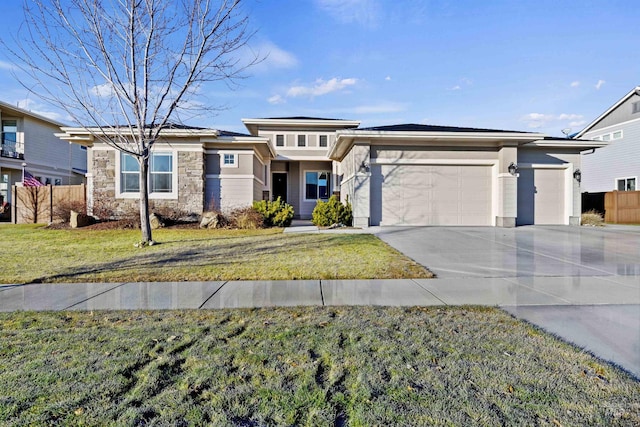 view of front of home with a front yard and a garage