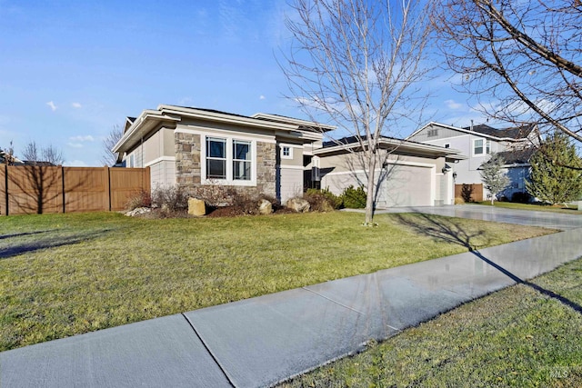 prairie-style house featuring a front yard and a garage