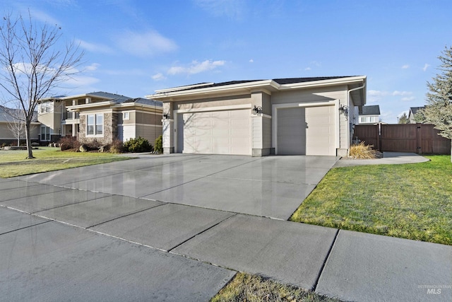 view of front of home featuring a front yard and a garage