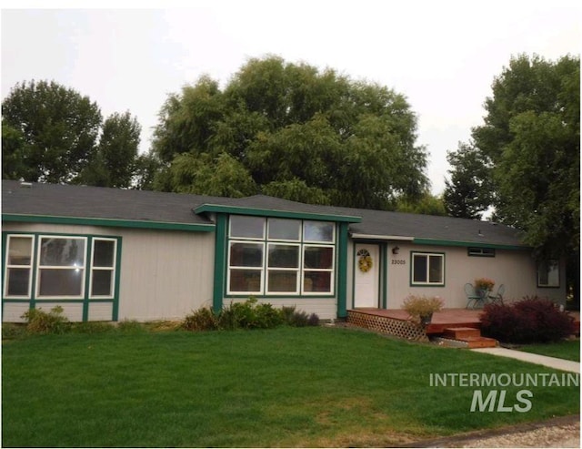 ranch-style home with a front lawn