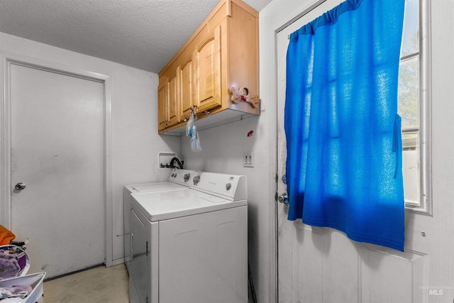 washroom featuring cabinets, washer / dryer, and a textured ceiling