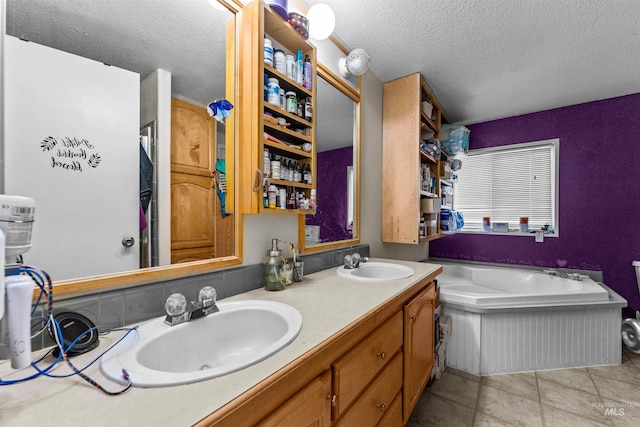bathroom with a textured ceiling, dual bowl vanity, tile floors, and a washtub