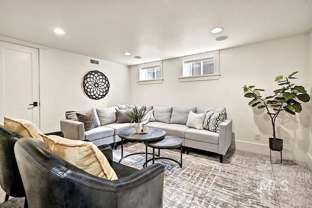 living room with visible vents, recessed lighting, and baseboards