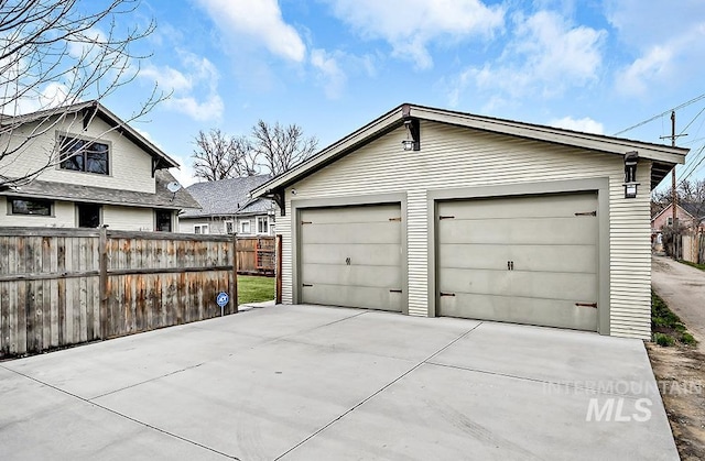 detached garage featuring fence