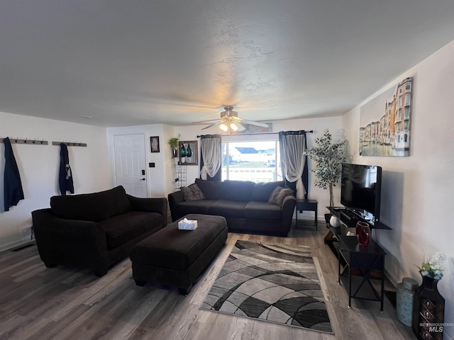 living area featuring ceiling fan and wood finished floors