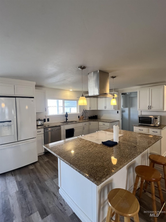 kitchen with stainless steel appliances, dark wood-style flooring, a kitchen island, white cabinets, and island exhaust hood