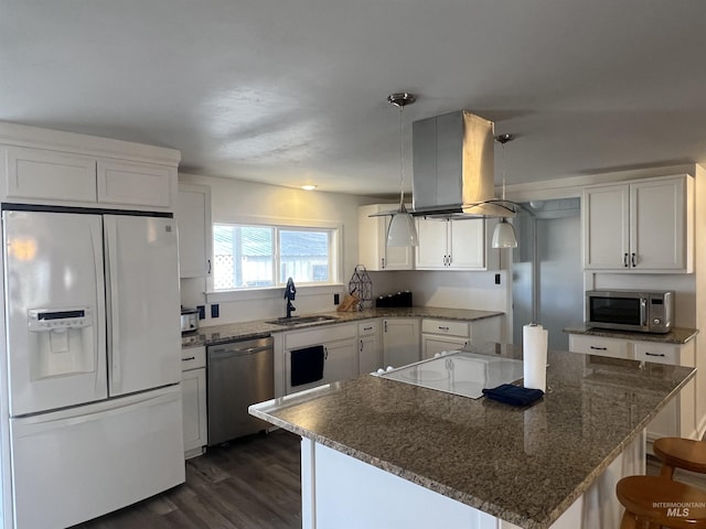 kitchen featuring dark wood-style floors, island exhaust hood, appliances with stainless steel finishes, white cabinetry, and a sink