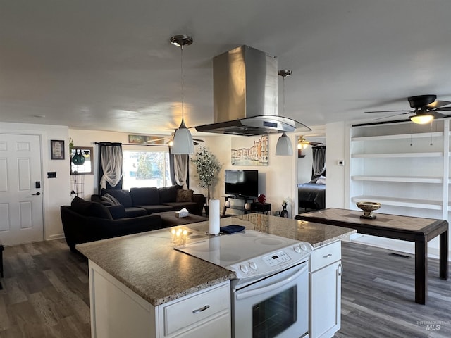 kitchen featuring open floor plan, white electric range, island range hood, and white cabinetry