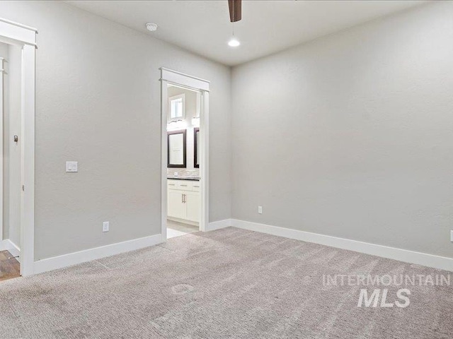 carpeted empty room with ceiling fan