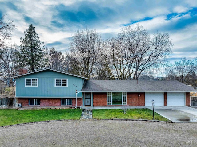 split level home featuring a front yard and a garage