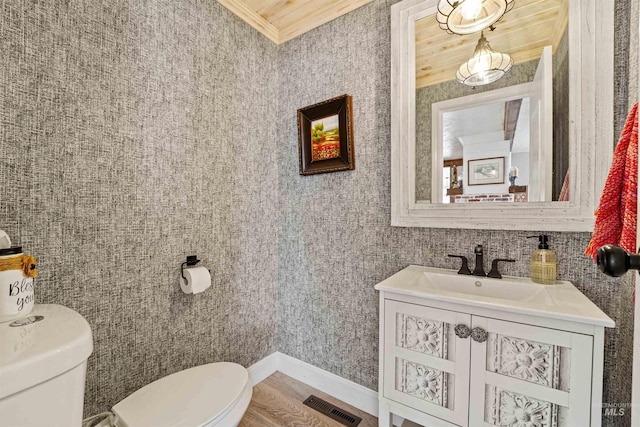 bathroom featuring visible vents, vanity, toilet, and crown molding