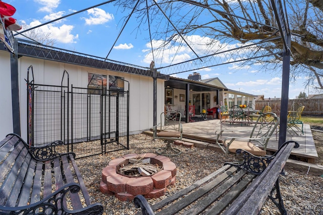 view of yard with an outdoor fire pit, fence, and a wooden deck