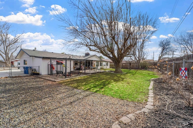 view of yard with a fenced backyard and a gate