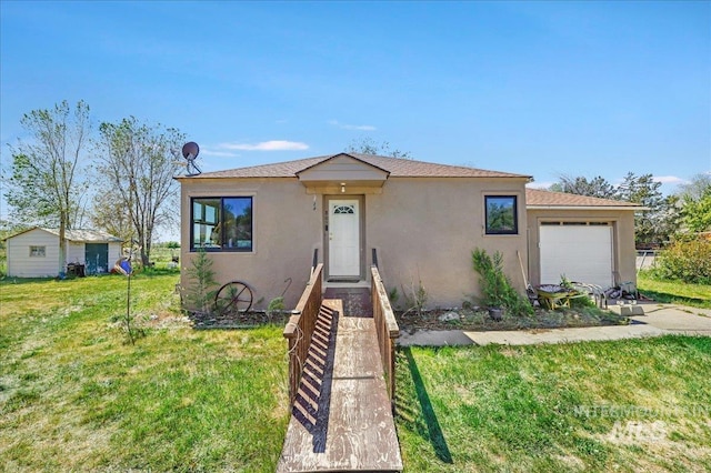 805 Utah, Gooding, ID 83330 - view of front of house with stucco siding, an attached garage, and a front lawn