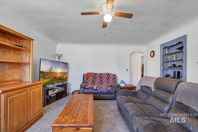 805 Utah, Gooding, ID 83330 - living room featuring arched walkways, light carpet, a ceiling fan, and a textured ceiling