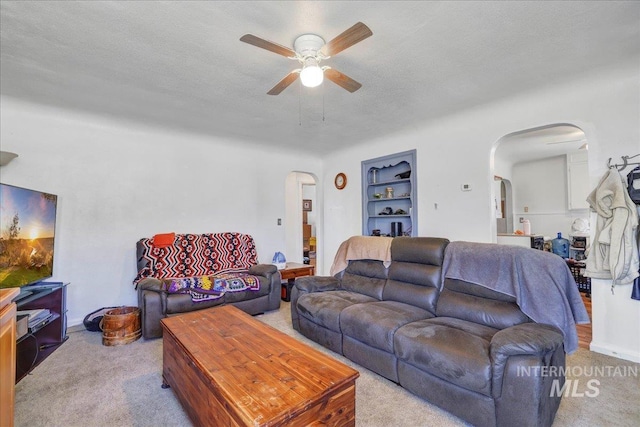 805 Utah, Gooding, ID 83330 - living area with arched walkways, ceiling fan, carpet floors, built in shelves, and a textured ceiling